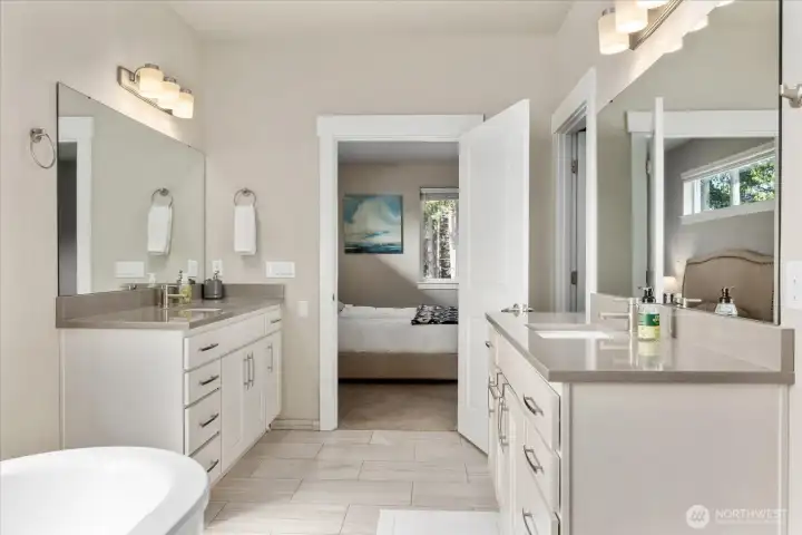 Dual-sink vanity with quartz countertops and ample storage for everyday ease.