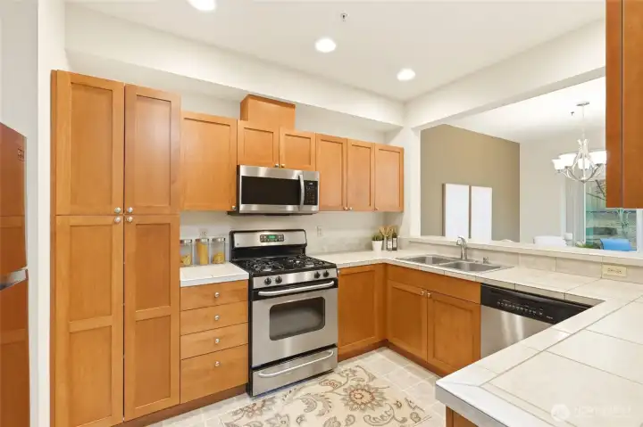 Chefs kitchen with gas range and stainless appliances with storage galore.