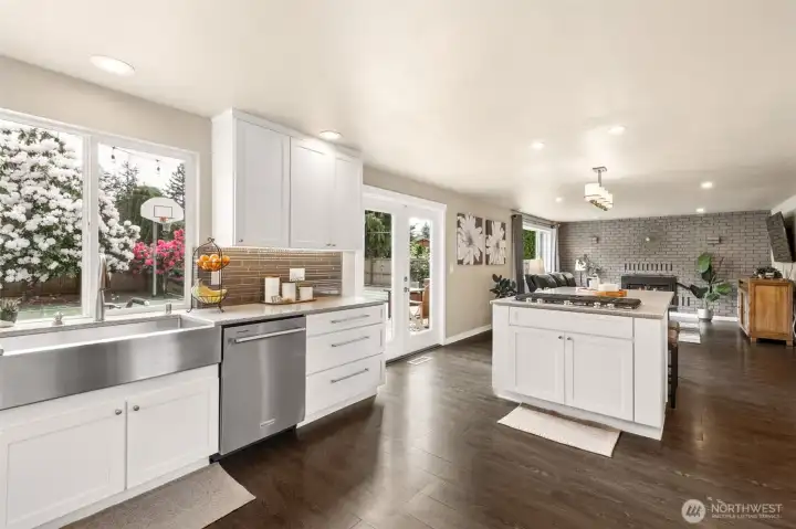 The center of the home! Slide easily into the dining room, out to the patio for the BBQ, or enjoy breakfast at the island bar, or grab coffee to savor in the family room.