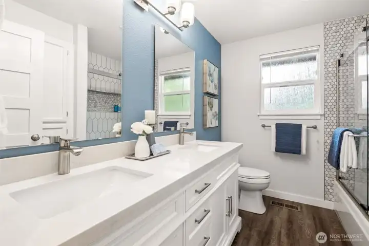 Upstairs hall bathroom ... double sinks and gorgeous countertops & tile, with built-in shelving.
