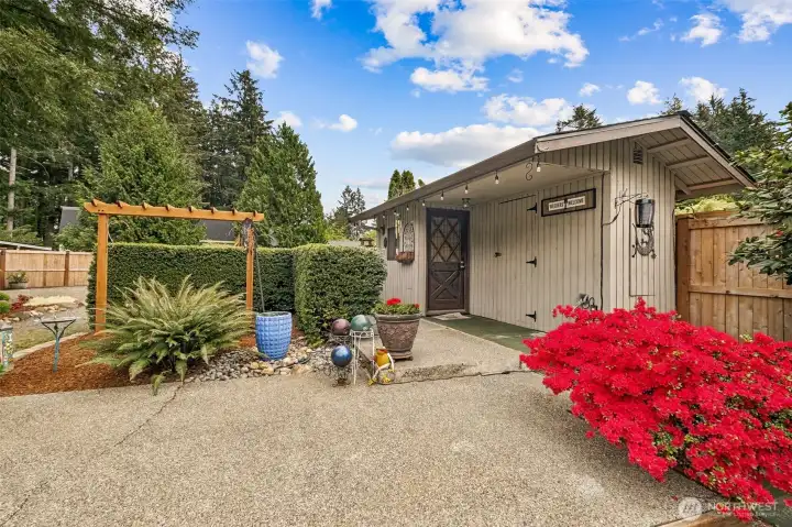 The garden shed is adorable from the outside - and wood-paneled on the inside!