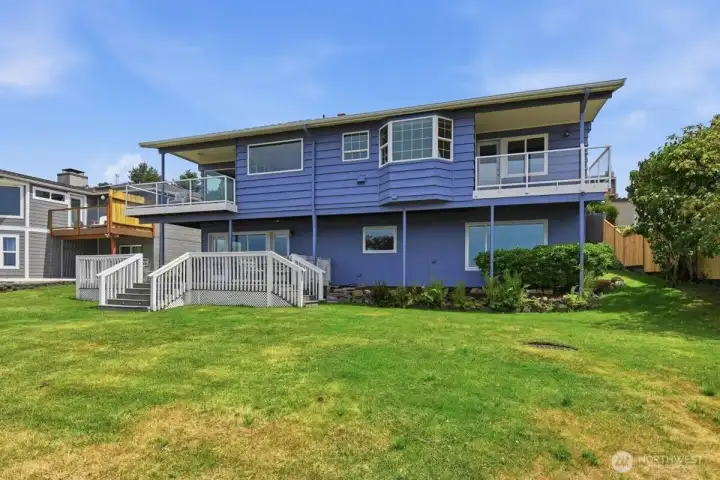 Back of home showing 3 covered decks