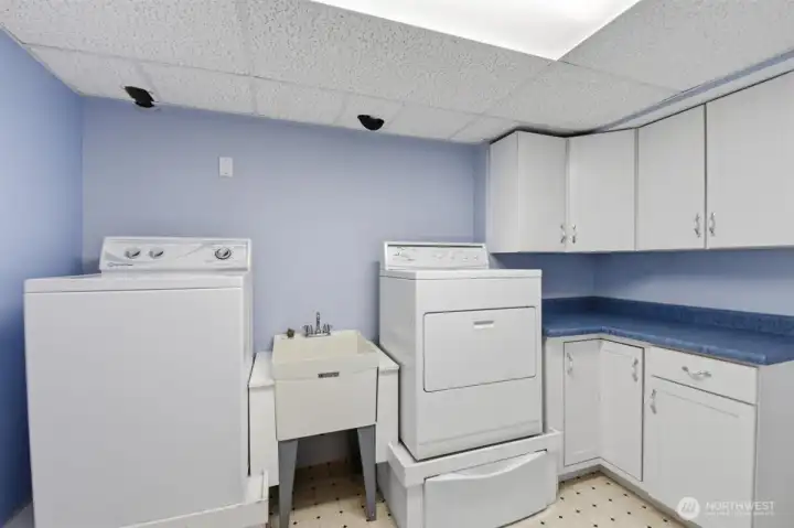 Convenient laundry with more that ample storage!