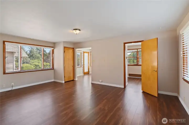 From dining room, view of living room, entry, and doorway on right is 2nd bedroom. From dining room, view of living room, entry, and doorway on right is 2nd bedroom.