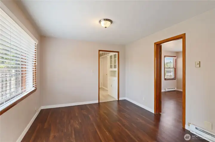 Dining room w/kitchen doorway straight ahead and primary bedroom to right. Dining room w/kitchen doorway straight ahead and primary bedroom to right.