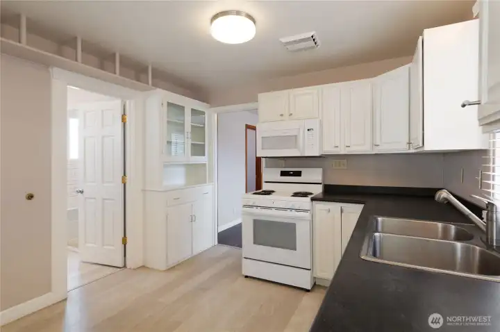 From other side of kitchen, door on left is full bath. Notice the classic built-in cabinet. From other side of kitchen, door on left is full bath. Notice the classic built-in cabinet.