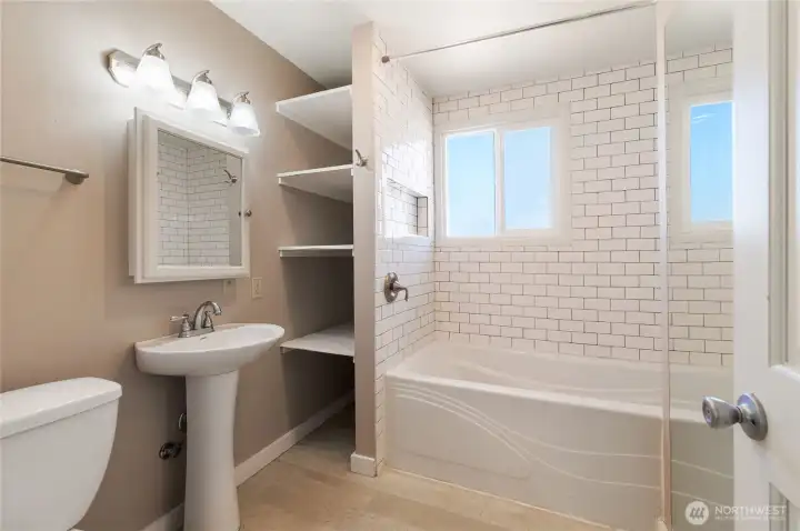 Full bathroom with tile tub surround. Full bathroom with tile tub surround.