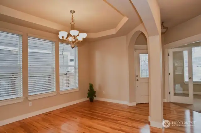 Formal dining area, with a view of the entry as well as the office/den.