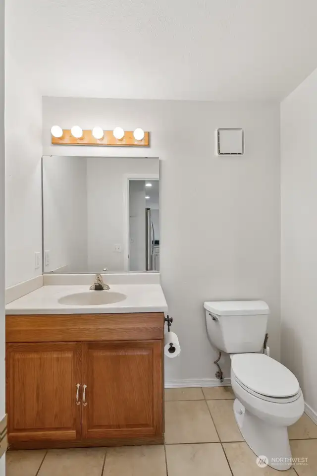 Simple, but so convenient. This powder room features easy-to-clean tile floors and a basic single-sink vanity, perfect for quick trips and guest use. It’s no-frills, but having it on the main floor is a game-changer for convenience.