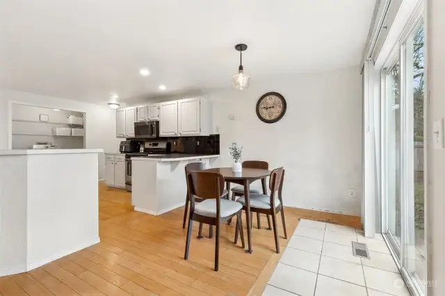 Perfectly placed between the kitchen and sliding glass door, this dining space makes every meal feel like an event. The tile floor inset near the door not only protects the bamboo flooring but adds a sleek, functional touch to the room’s flow.