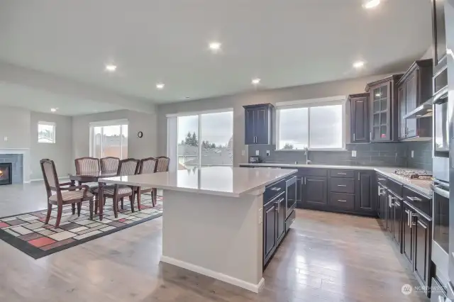 Kitchen and eat-in space facing great room