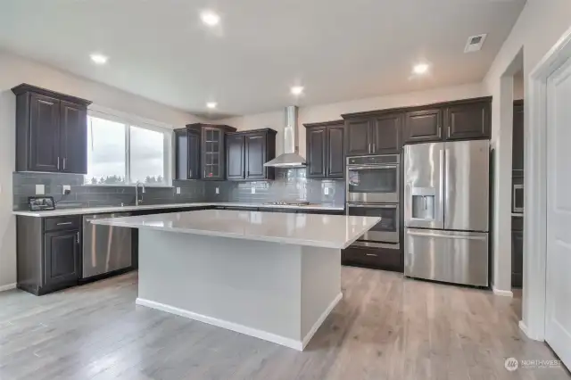 Splendid kitchen with quartz counter tops and spacious island