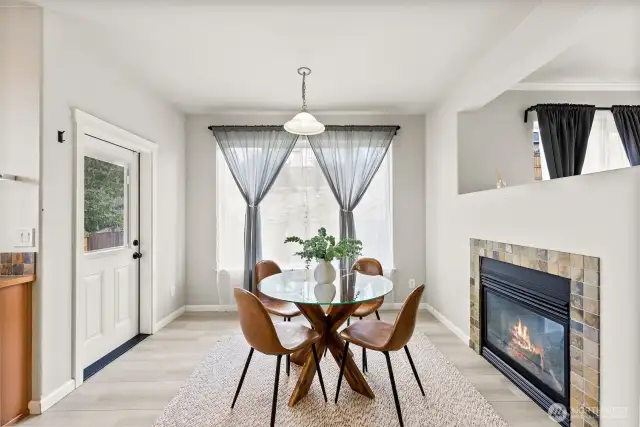 A delightful breakfast nook enjoys the other side of the fireplace for a charming atmosphere making everyday meals feel special.