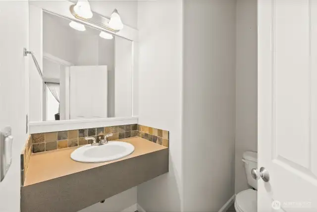 Handsome powder room to serve your guests on main level.