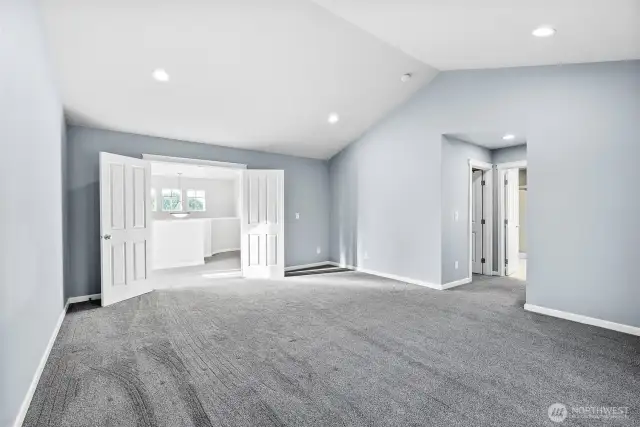 Presenting the primary bedroom as double French doors open up to your own personal retreat.