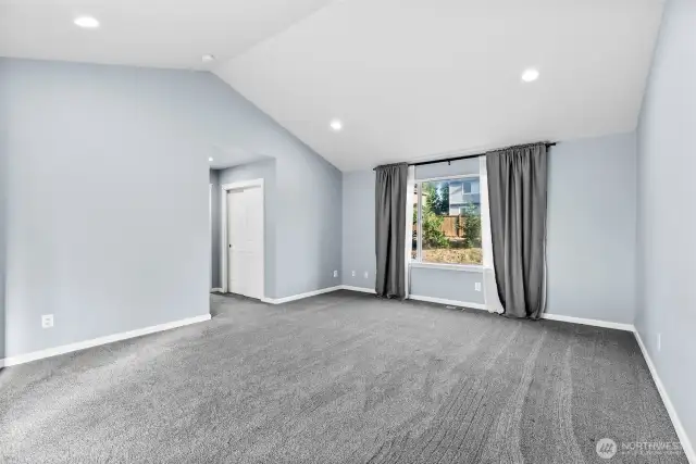 Vaulted ceiling with recessed lighting gives the perfect balance to the soft neutral tones.
