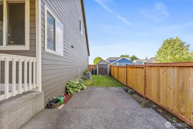 Shed is tucked away in corner of yard discretely out of the way.