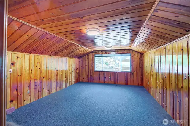 One of two upper level bedrooms with 2 storage closets.