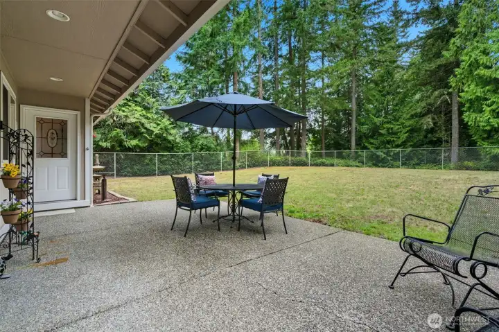 Lovely patio for large or small gatherings. The back property line continues well beyond the fence line.