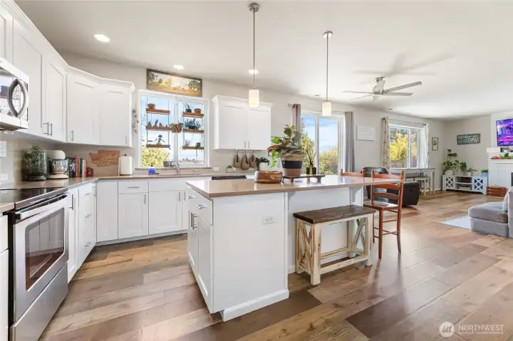 Open concept kitchen with coffee nook, center island and view of Mt. Rainier, living room