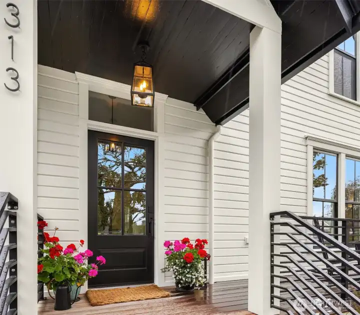 Welcoming front porch with all new decking, railings and cobblestone entry path.