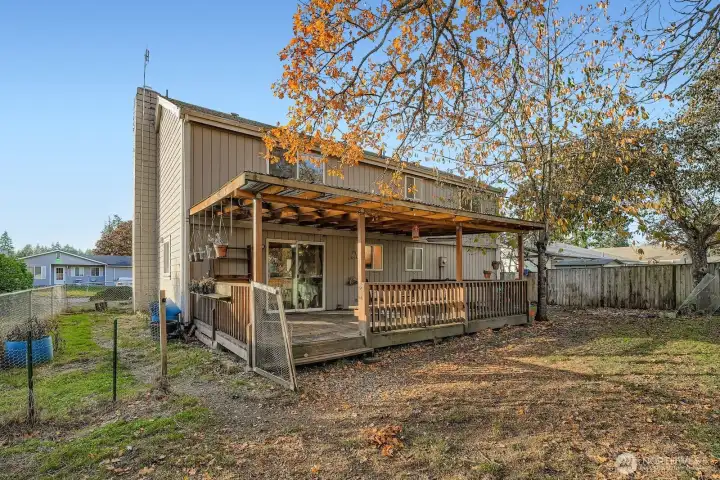 Fully fenced yard & approx. 300' covered wood deck. Dog run set up on this side yard
