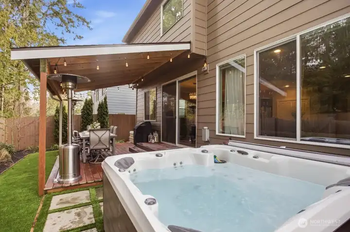 Extended paver patio with private hot tub retreat—an understated luxury designed for year-round relaxation.