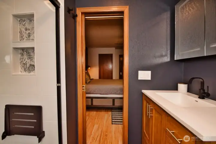 Primary bath. Notice the shower nooks and seat for convenience.