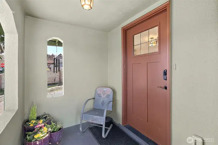 Covered porch with pass through views. Large front door with craftsman charm and a touchpad deadbolt lock.