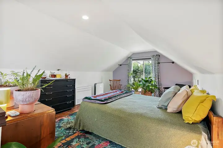 Half of the finished attic space turned into primary bedroom space.