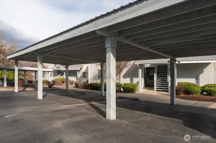 Covered carport parking space plus another uncovered parking space.