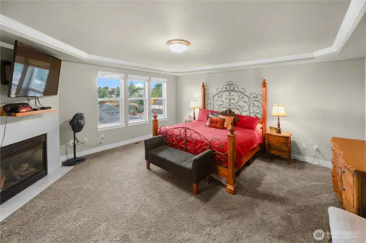 Moving upstairs, large primary bedroom with fireplace