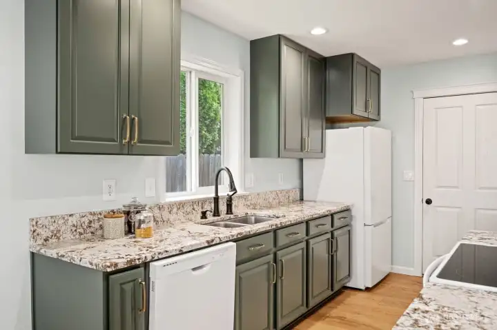 Galley kitchen with view to privacy hedge