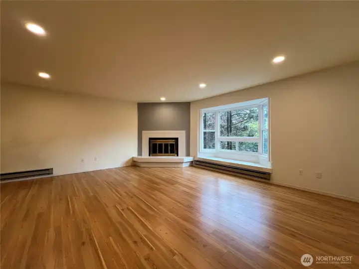 This is the living room w/ bow window & fireplace.