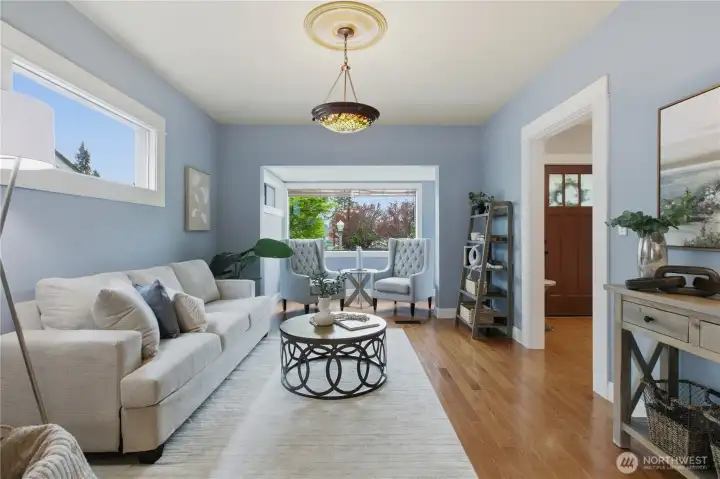 Expansive open living room with neat alcove sitting area facing the front yard. Notice the craftsman lighting fixtures and amazing trimwork!