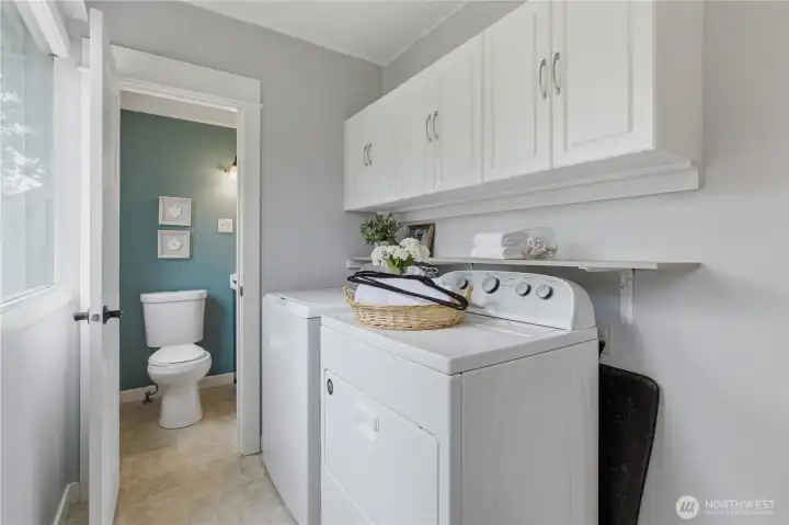 Laundry room on the main floor... washer and dryer are included, and you will love the newer white cabinets installed above for storage.