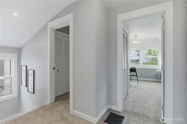 Upstairs hallway at the top of the stairs landing. Notice the gorgeous craftsman trimwork and moldings on all the doors and windows in this home!