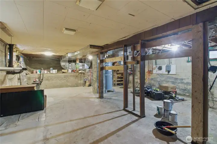 Basement view number two... there is good ceiling height (finish later?), a new hot water tank in 2026, and the electrical 200 amp service has been updated as well.