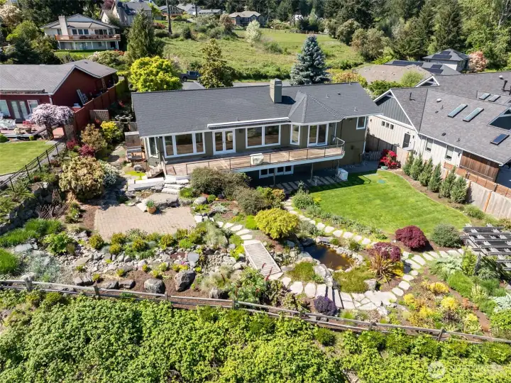 This high bank water view custom home is  perched above the southern tip of Fox Island.  The views stretch from iconic Mt. Rainier to  the majestic Olympic Mountains and beyond.  New awning in summer of 2025.
