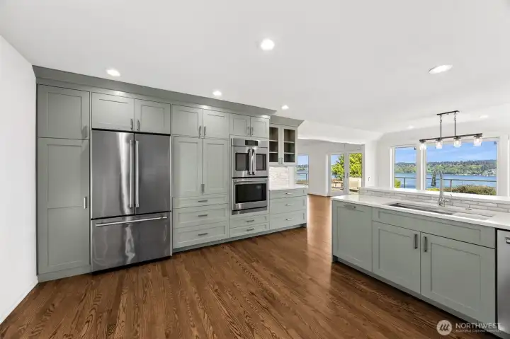 This beautifully appointed chefs kitchen is designed with the culinary excellence in mind- professional stainless steel appliances, custom cabinetry, quartz countertops that all comes together with the views of the water.