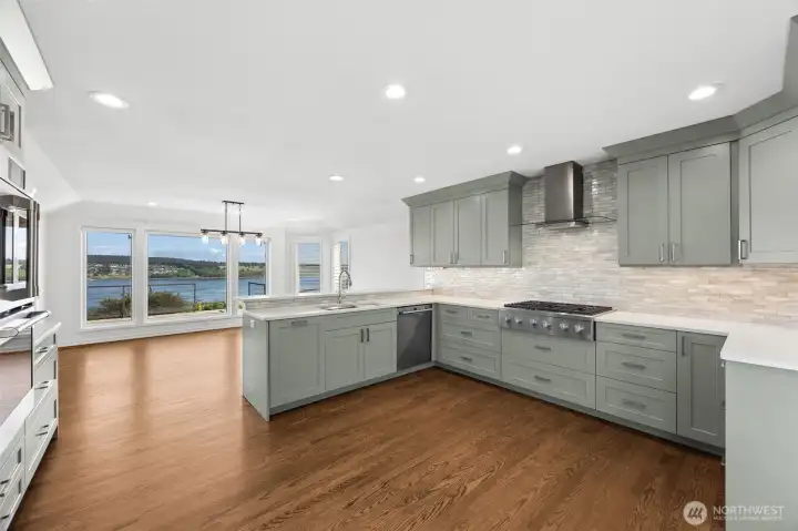 The gourmet kitchen—complete with a breakfast bar and professional-grade appliances—is designed for quiet mornings or crowd hosting dinners.