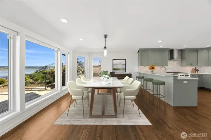 The dining room offers a beautifully proportioned space designed for both everyday enjoyment and memorable gatherings. Expansive windows capture sweeping views of Chambers Bay, Mt. Rainier, and the surrounding landscape, creating a constantly changing backdrop that elevates every meal. (staged photo)