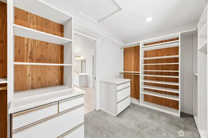 Custom Primary walk in closet with cedar lined shelves and built in cabinets.