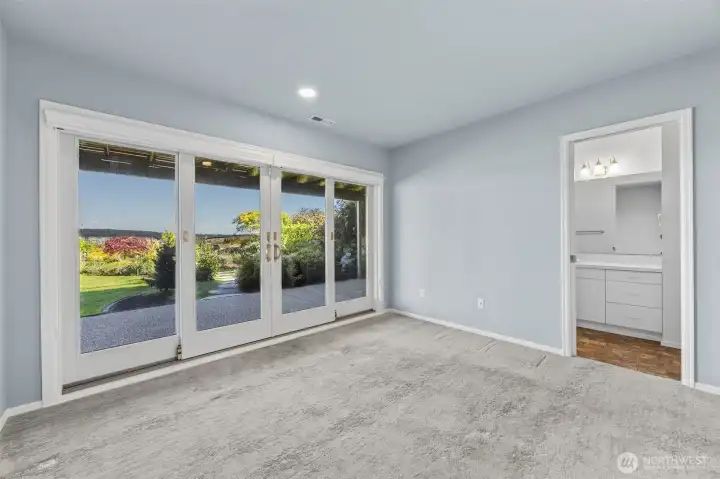 Don't miss the second primary suite on the lower level with large sliding door that spans the entire wall. Wake up to peaceful green views and step directly outside to enjoy morning coffee or quiet evenings surrounded by nature.