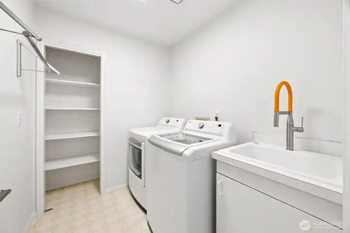Lower level laundry room with storage closet & deep sink area. Not pictured here is the NEW HVAC system in 2025 and newer water heater in 2023.