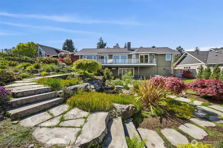 Winding through the private gardens, thoughtfully placed stepping stones create a charming and inviting pathway that enhances the sense of tranquility.