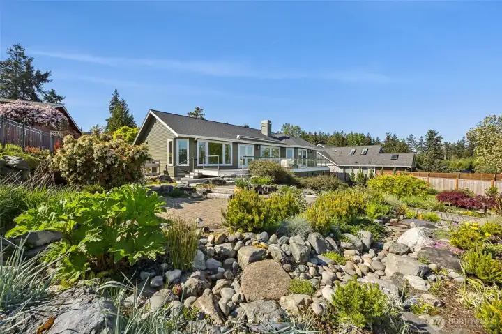 Serene park like back yard with sprawling gardens, dry river bed, Koi pond- any gardener will not be disappointed in this oasis.