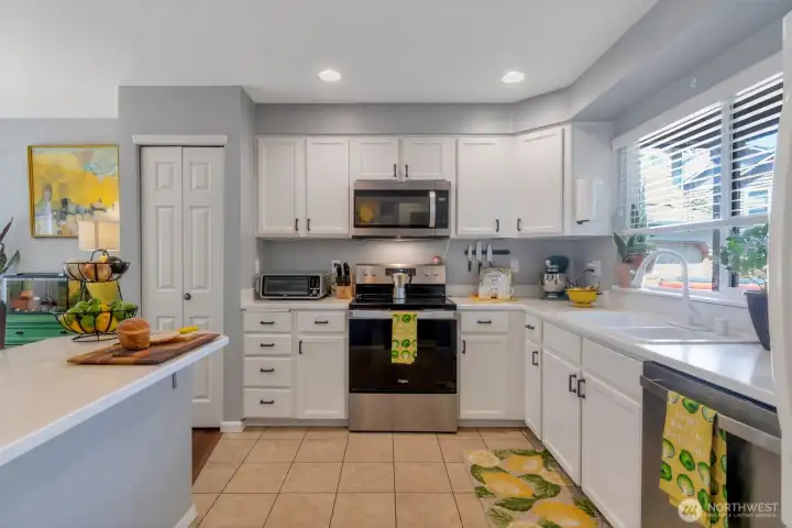 Bright eat-in kitchen with island/bar & newer SS appliances. Microwave & Stove replaced in 2023. 3-rack dishwasher replaced in 2025.