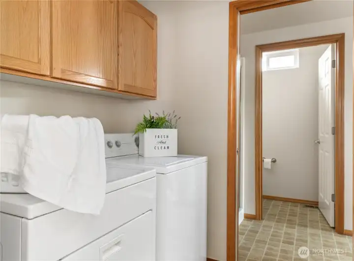 Laundry area with nice cabinets above washer and dryer