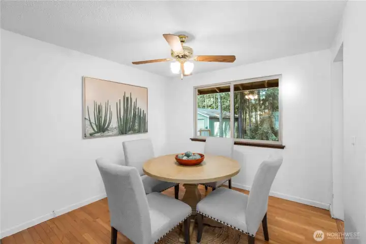 Dining room that opens to the Kitchen and Living Room and a large window that overlooks the backyard.